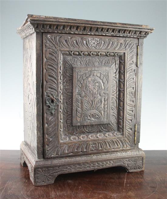 A carved oak cabinet, W.1ft 3in.